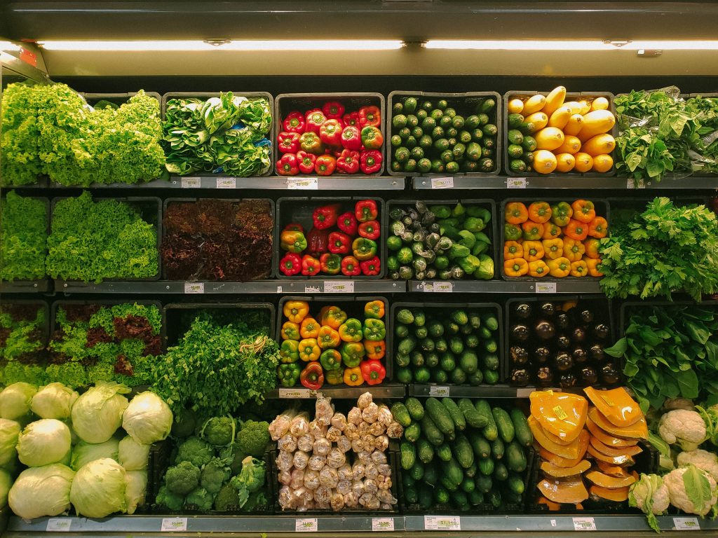Four rows of neatly organised fresh produce in a store refridgerator